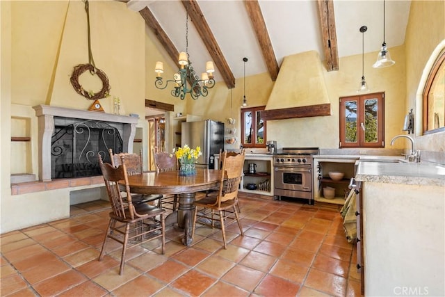 dining area with sink, high vaulted ceiling, beamed ceiling, tile patterned floors, and a fireplace