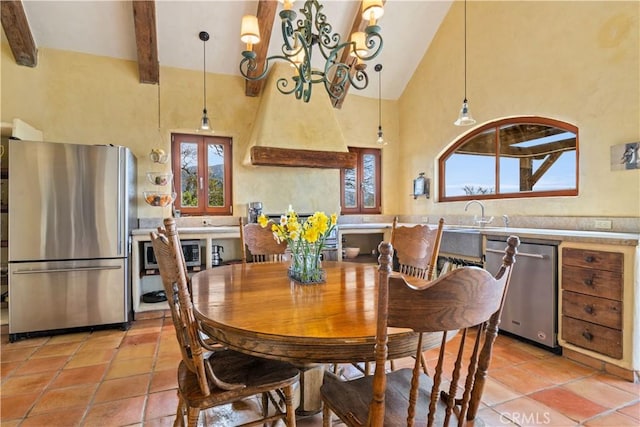 tiled dining area featuring beam ceiling, sink, high vaulted ceiling, and a chandelier