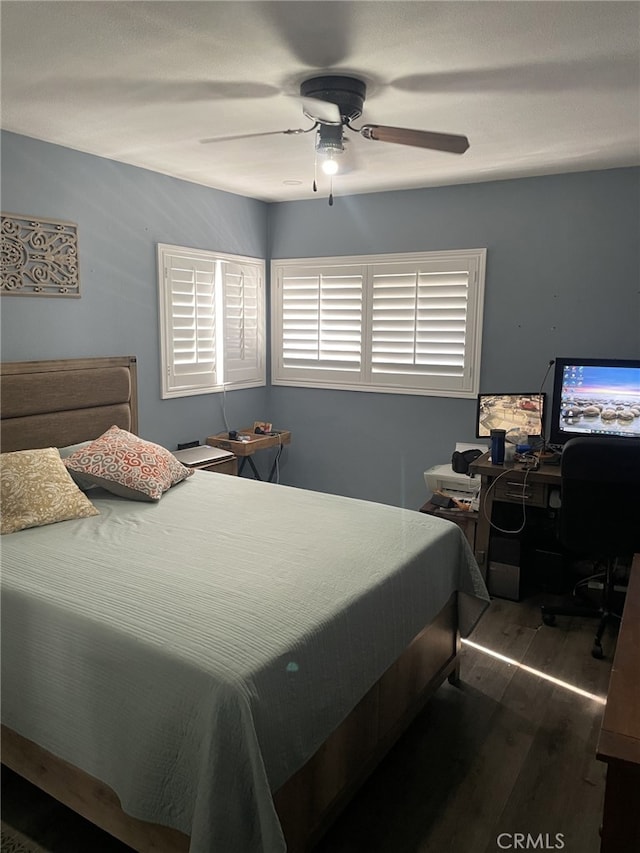 bedroom featuring hardwood / wood-style floors and ceiling fan