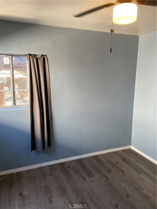 unfurnished room featuring ceiling fan and dark wood-type flooring