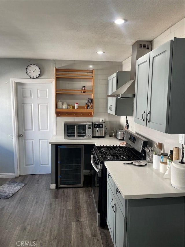 kitchen featuring wine cooler, dark hardwood / wood-style floors, gray cabinets, a textured ceiling, and appliances with stainless steel finishes