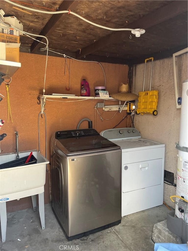 laundry area with gas water heater and separate washer and dryer