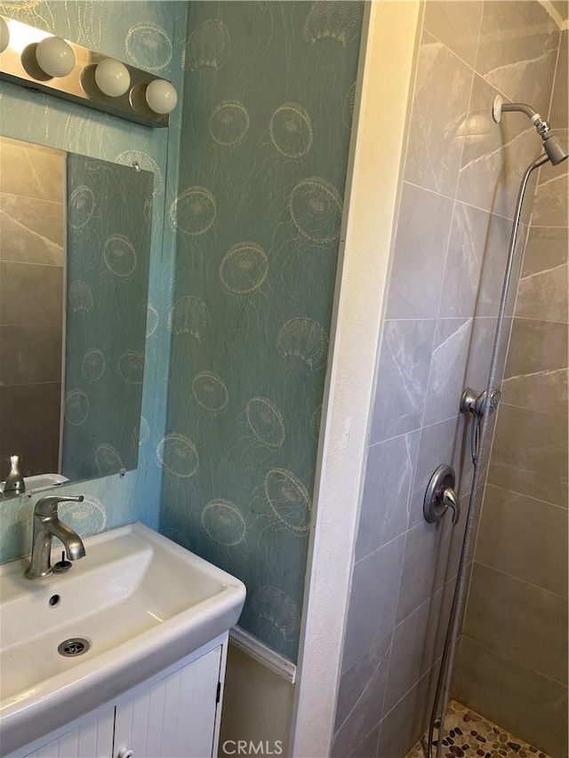 bathroom featuring vanity and tiled shower