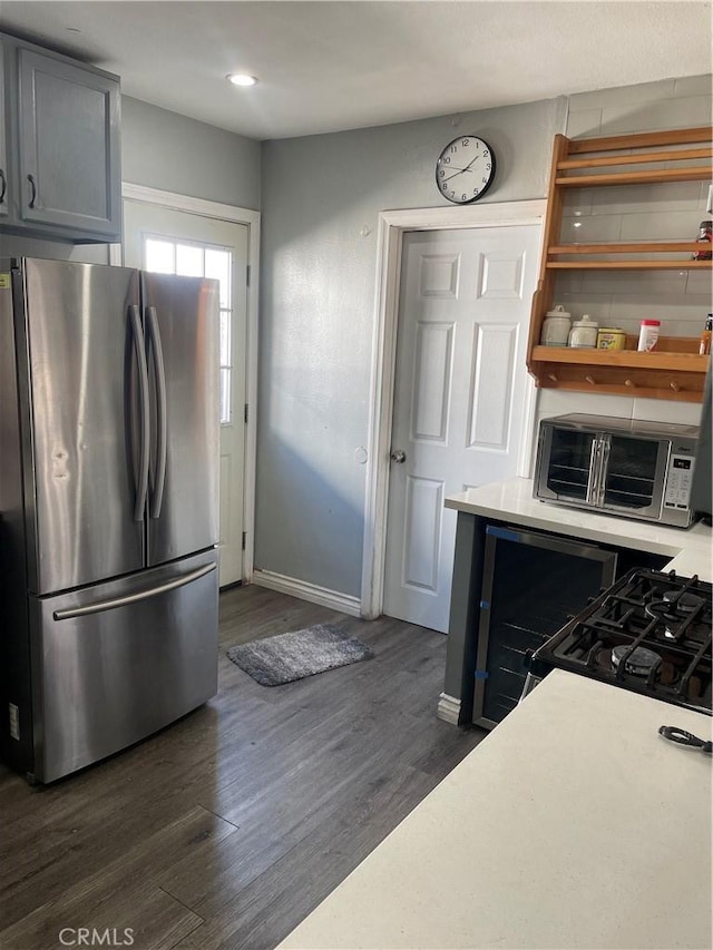 kitchen featuring dark hardwood / wood-style floors, stainless steel refrigerator, and gray cabinetry