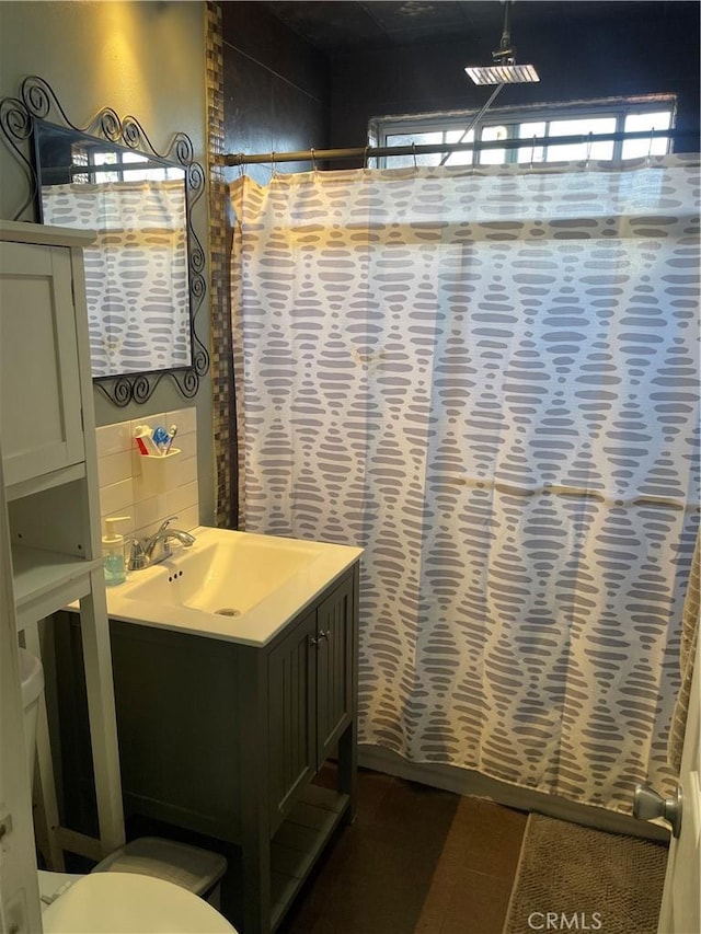 bathroom featuring vanity, toilet, and plenty of natural light