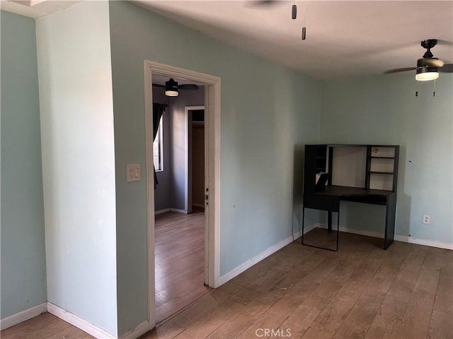 spare room with wood-type flooring and ceiling fan