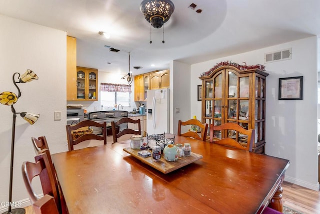 dining space with light wood-type flooring