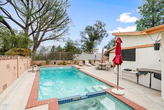 view of pool featuring a mountain view and a patio area