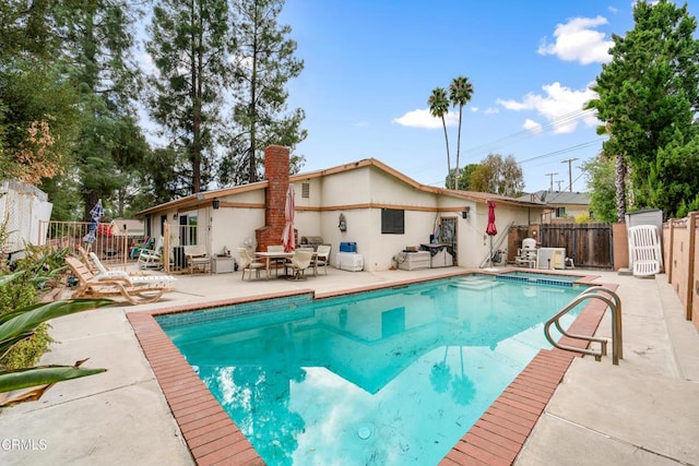 view of swimming pool with a patio area