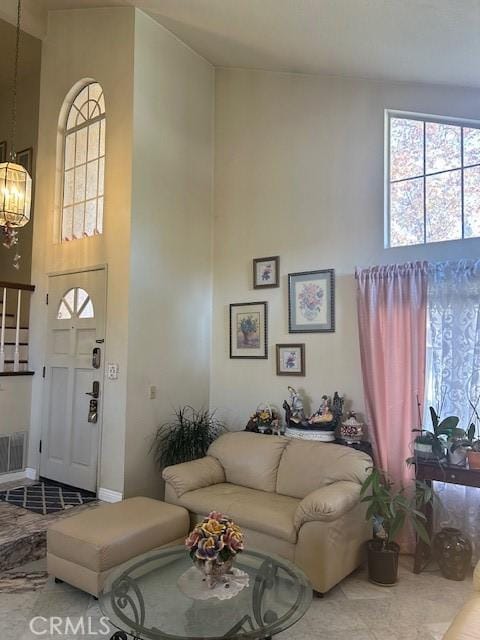 living room with a high ceiling and a chandelier