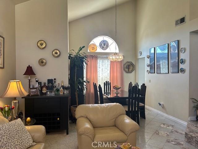 dining area featuring a wealth of natural light and high vaulted ceiling