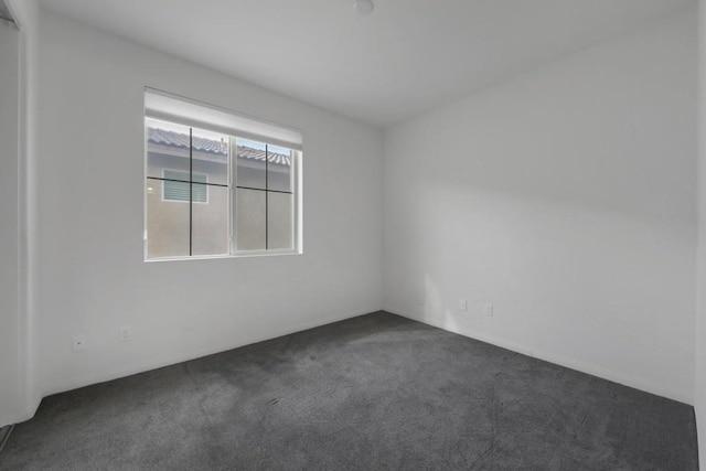 empty room with dark colored carpet