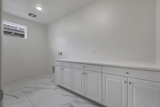 laundry room featuring cabinets