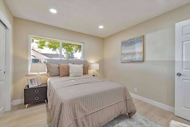 bedroom featuring a closet and light wood-type flooring