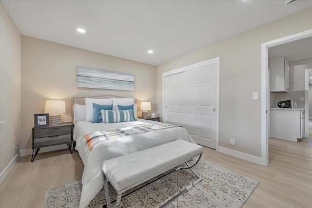 bedroom featuring a closet and light hardwood / wood-style flooring