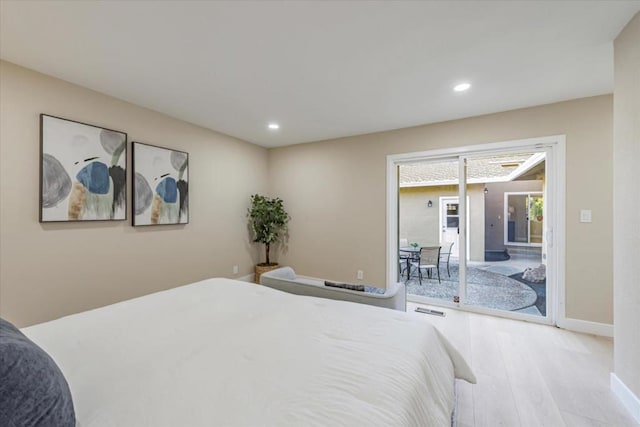 bedroom featuring light wood-type flooring and access to outside