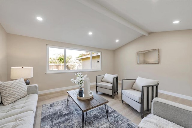 living room with vaulted ceiling with beams and light hardwood / wood-style flooring