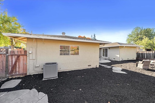 rear view of house featuring central AC