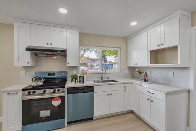 kitchen with white cabinetry, appliances with stainless steel finishes, sink, and light hardwood / wood-style floors