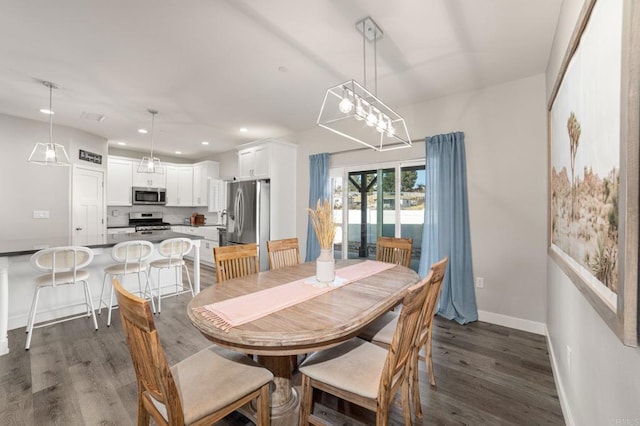 dining room featuring dark hardwood / wood-style floors and an inviting chandelier