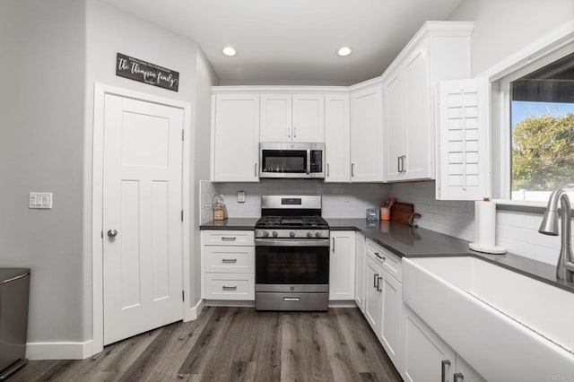 kitchen featuring white cabinets, sink, and appliances with stainless steel finishes