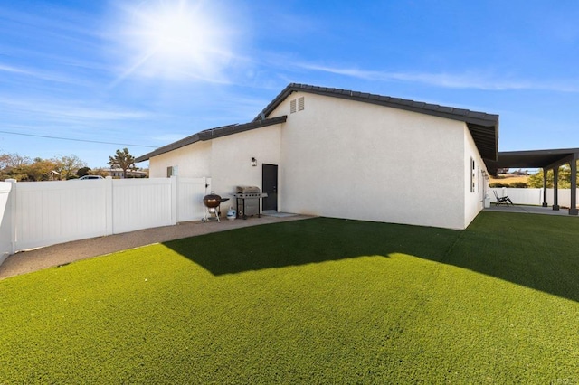 back of house with a lawn