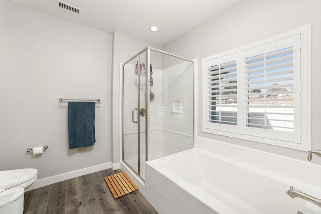 bathroom featuring hardwood / wood-style floors, separate shower and tub, toilet, and a bidet