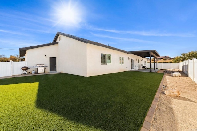 back of property featuring a lawn and a patio