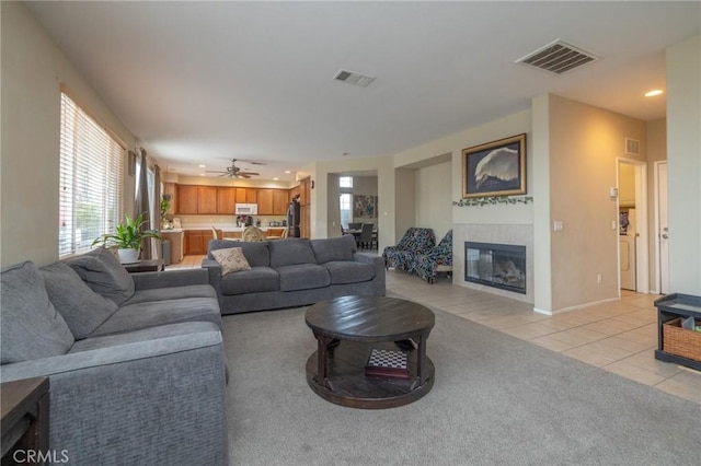 living room with ceiling fan and light tile patterned floors