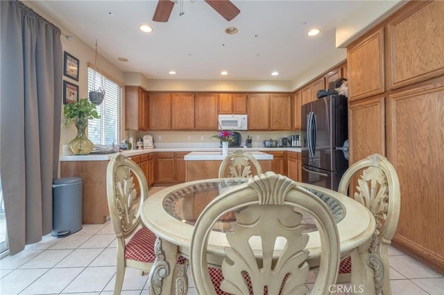 kitchen featuring ceiling fan, light tile patterned flooring, and stainless steel fridge