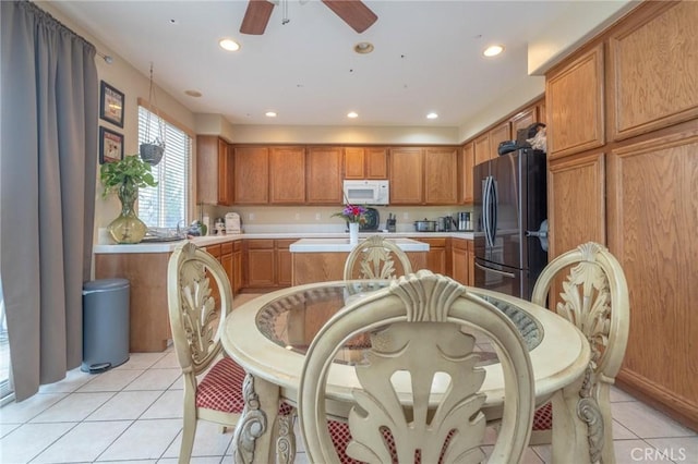 kitchen with light tile patterned floors, stainless steel fridge, and ceiling fan