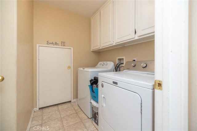 laundry room featuring washer and dryer and cabinets