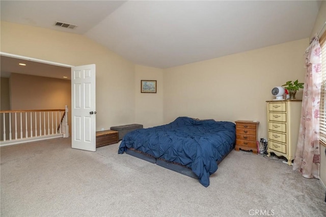 carpeted bedroom with vaulted ceiling