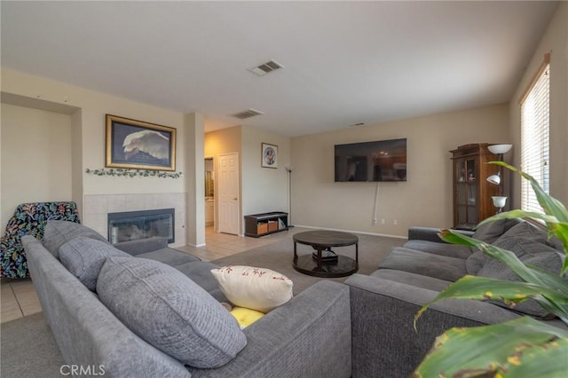 living room featuring light tile patterned floors and a fireplace