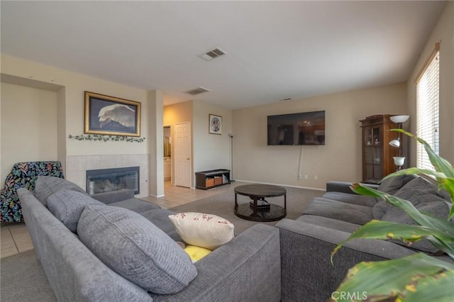 tiled living room featuring a tiled fireplace