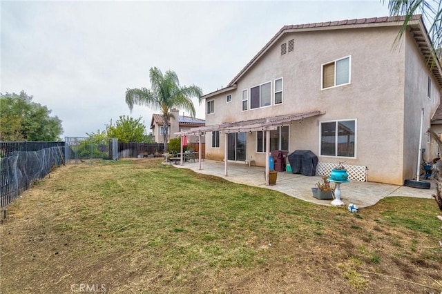 rear view of house featuring a patio area, a yard, and a pergola