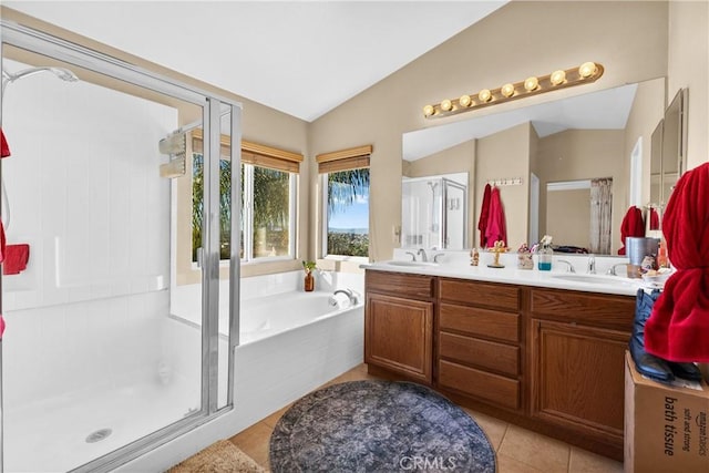 bathroom with tile patterned flooring, vanity, lofted ceiling, and shower with separate bathtub