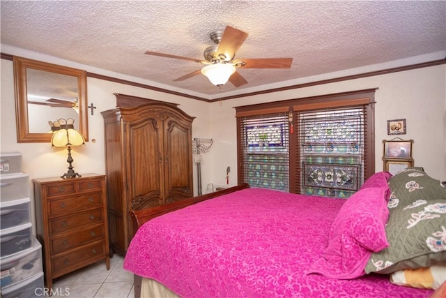 bedroom with a textured ceiling, ceiling fan, and light tile patterned flooring