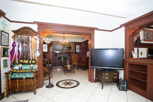 living room featuring ornamental molding, a brick fireplace, a notable chandelier, and light tile patterned flooring