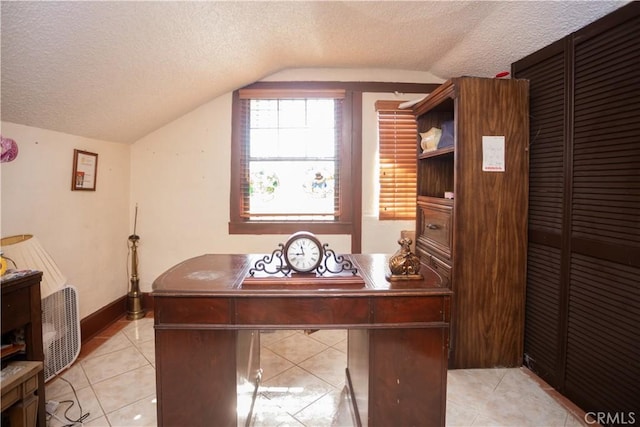 tiled home office with a textured ceiling and lofted ceiling