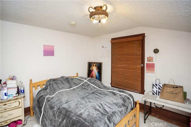 bedroom featuring light tile patterned floors and a textured ceiling