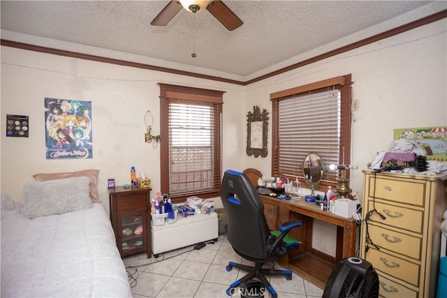 bedroom with ceiling fan, crown molding, light tile patterned floors, and a textured ceiling