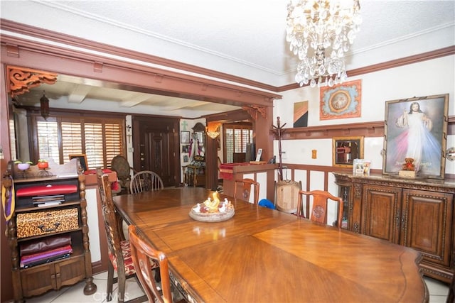 dining room featuring a textured ceiling, crown molding, light tile patterned floors, a notable chandelier, and beamed ceiling