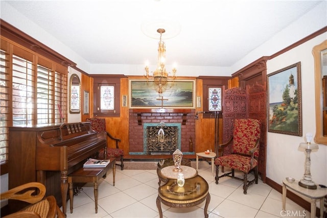 sitting room featuring a chandelier, light tile patterned floors, and a brick fireplace