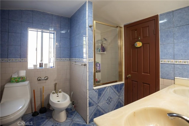 bathroom featuring a bidet, tile patterned flooring, toilet, tile walls, and a shower with shower door