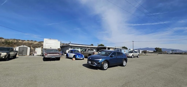 view of car parking with a mountain view