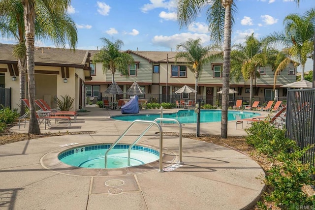 view of swimming pool with a community hot tub and a patio