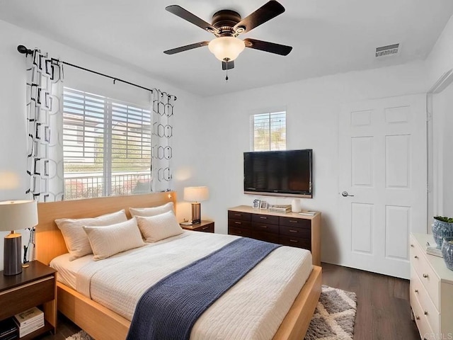 bedroom with ceiling fan and dark hardwood / wood-style flooring