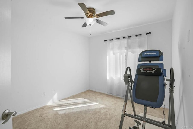 workout room featuring ceiling fan and light colored carpet