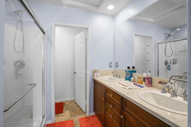 bathroom with a shower with door and vanity